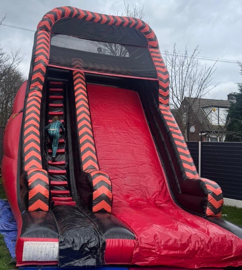 Red / Black Mega Slide bouncy castle for hire in Leeds